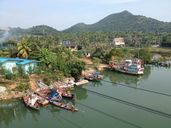 Thai fishing boats from a bridge over the river.