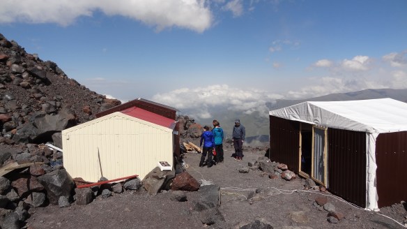 The 'flappy roof' hut on the right, which housed nine of us, the kitchen hut on the left.