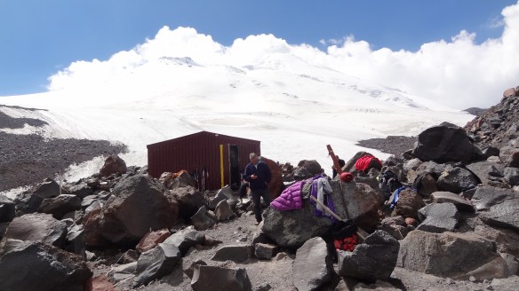 Viktor ponders what to do whilst the clouds begin to gather at pace over the summit.